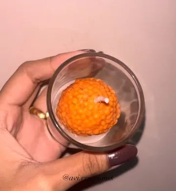 Laddoo candle shot held in a glass